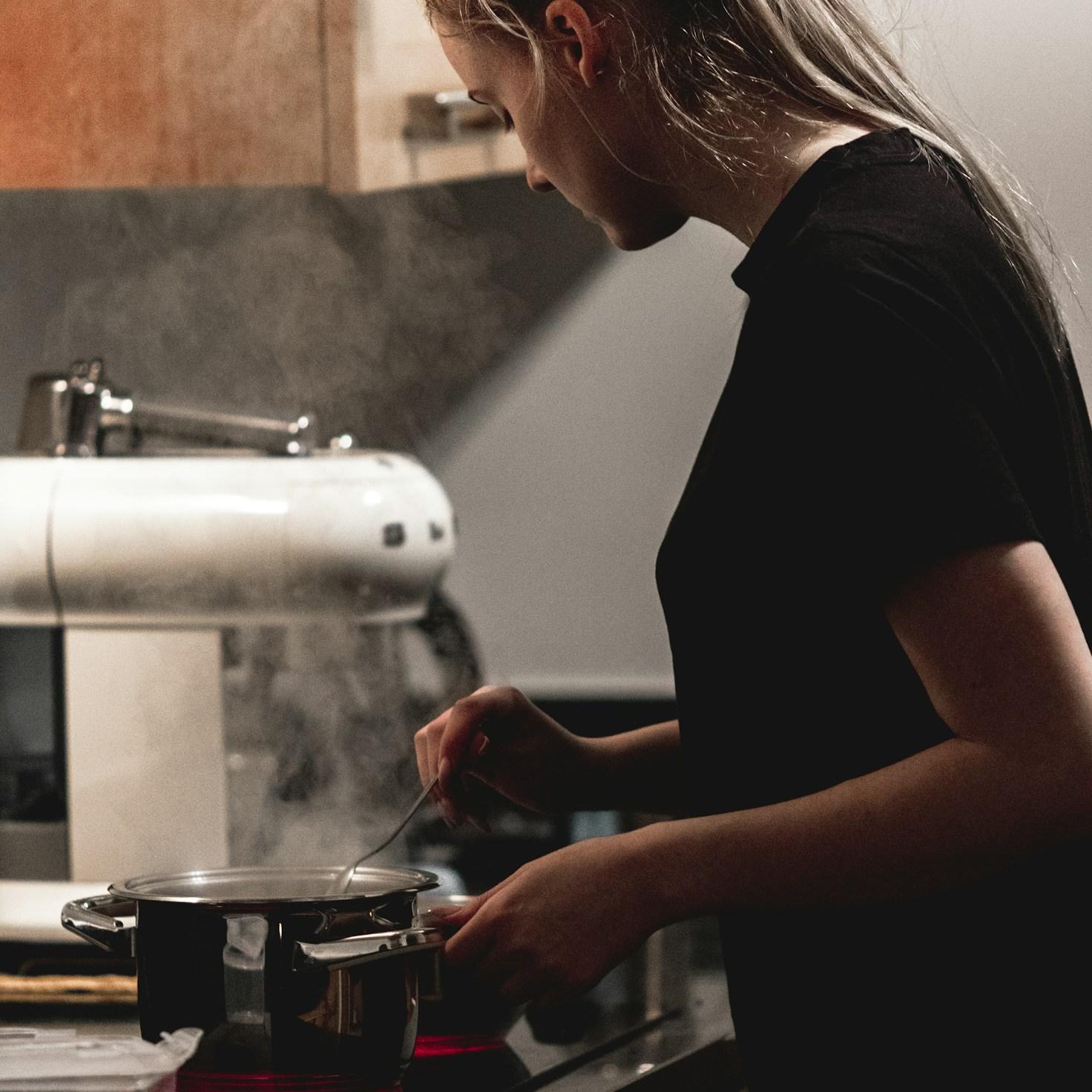 Diverse group of community members sharing a meal together, showcasing the social bonds formed through collaborative cooking